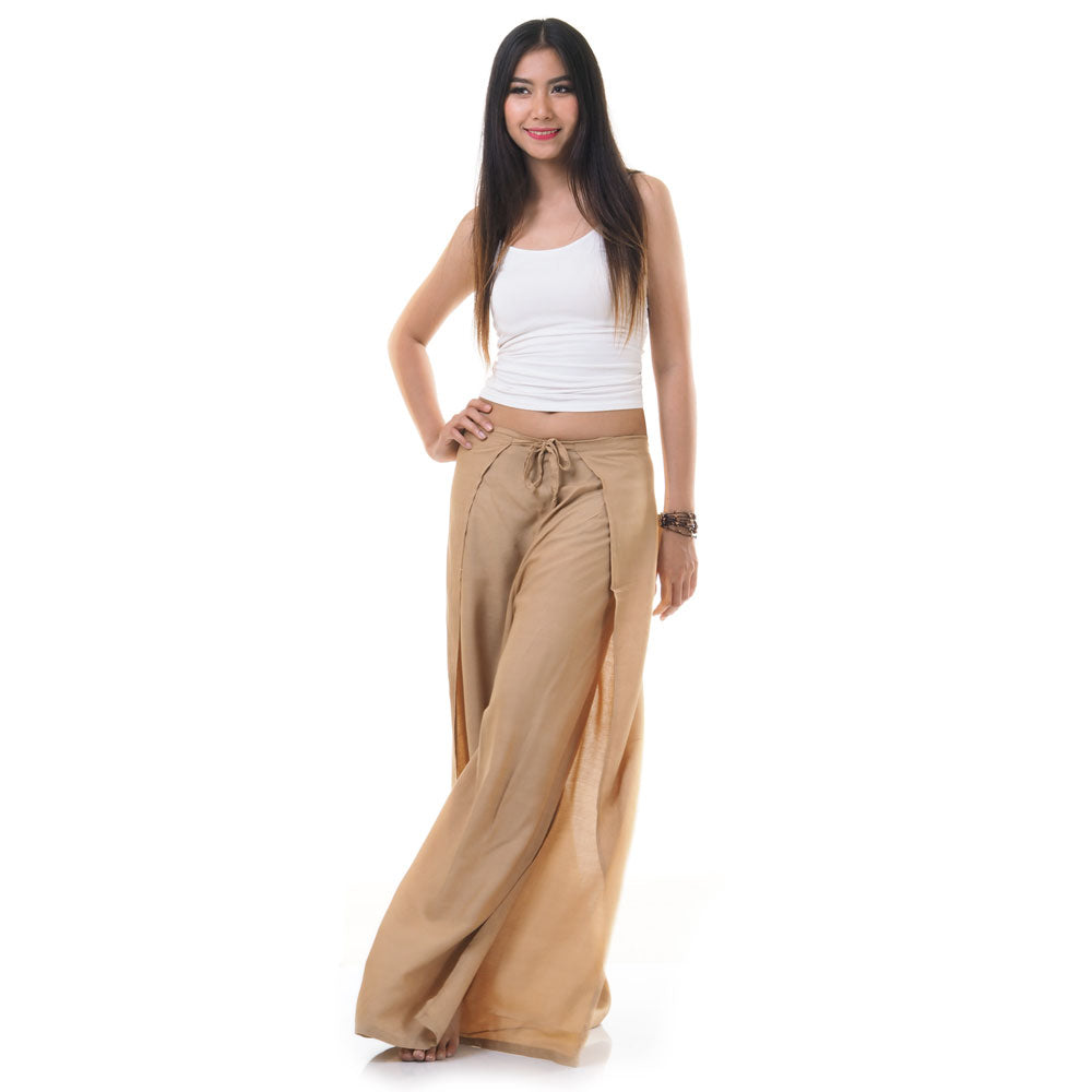 Model wearing beige Thai wrap pants skirt with white top, front view