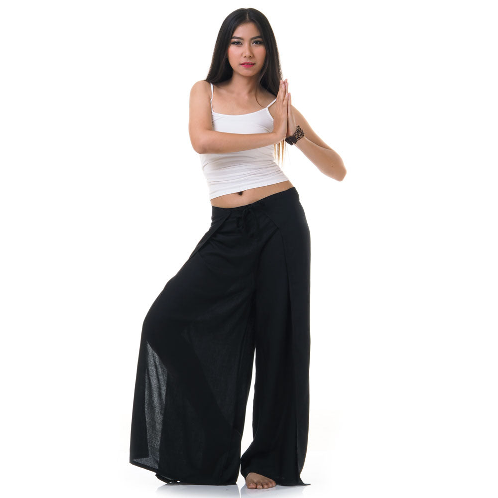 Model wearing black Thai wrap pants skirt with white top, front view