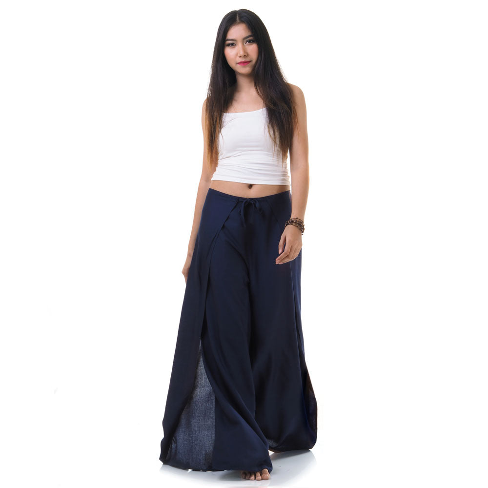 Model wearing blue Thai wrap pants skirt with white top, front view