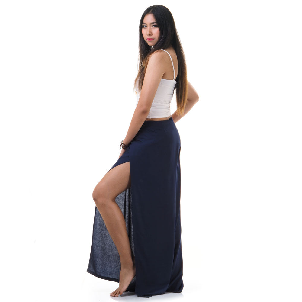 Side view of model in blue Thai wrap pants skirt with white top