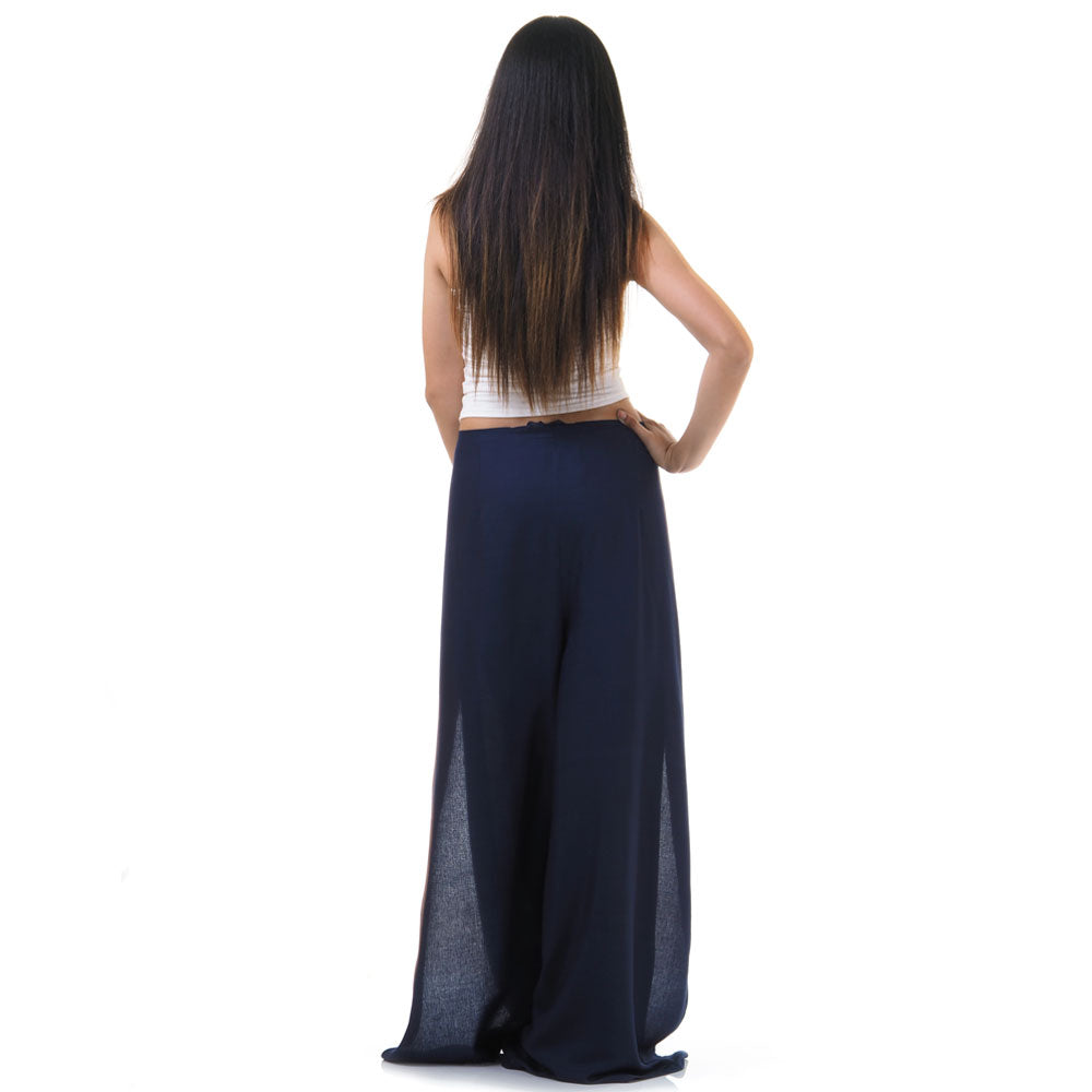 Back view of blue Thai wrap pants skirt worn with white top