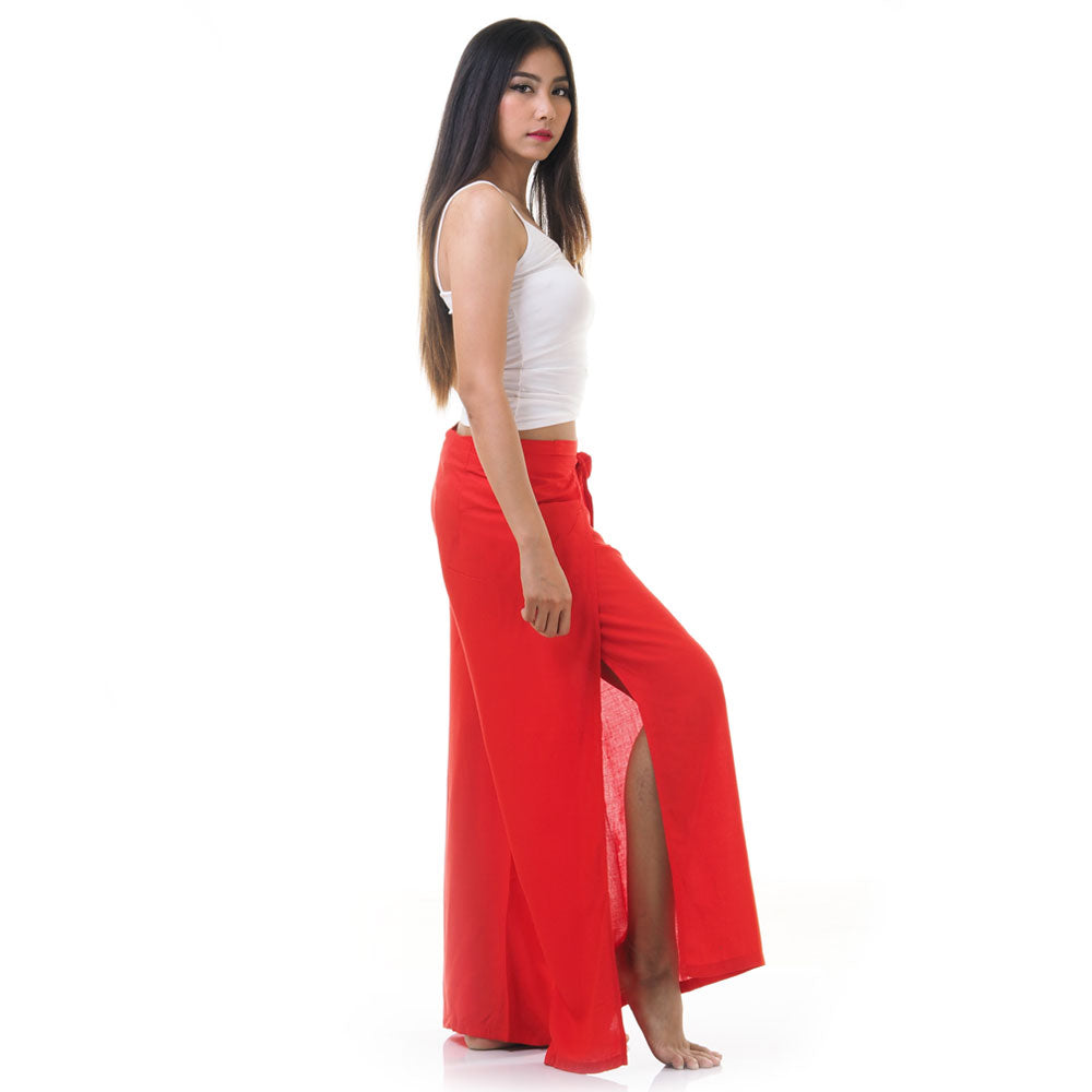 Side view of model in red Thai wrap pants skirt with white top