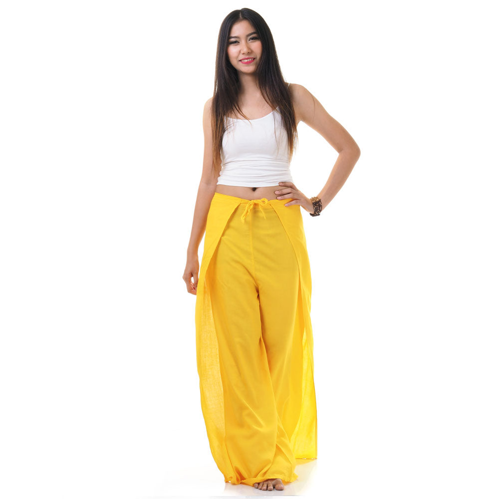 Model wearing yellow Thai wrap pants skirt with white top, front view