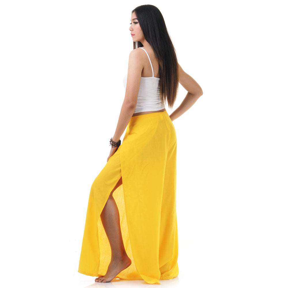Side view of model in yellow Thai wrap pants skirt with white top