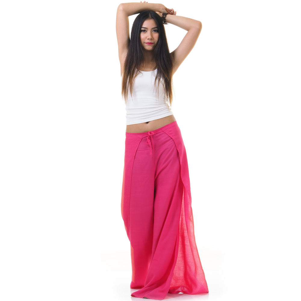 Model wearing pink Thai wrap pants skirt with white top, front view