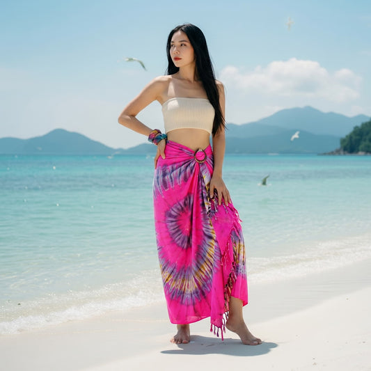 Female model enjoying the sun in the bold Pink Paradise Samui Tie Dye wrap skirt.