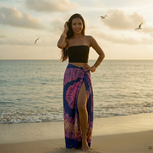 Female model in a tropical setting wearing the Purple Tie Dye wrap skirt Samui by the ocean.