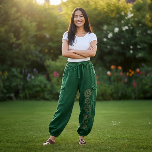 Woman posing in green boho stonewashed om pants in a sunny park, front view with side pockets.