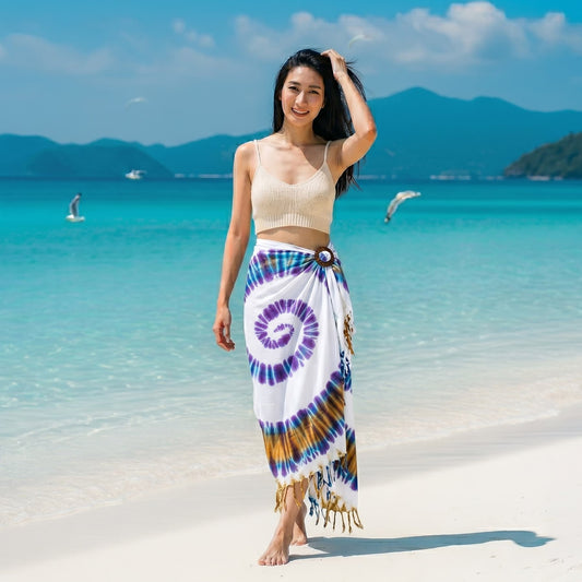 Female model walking on a Thai beach wearing the breezy White Tie Dye wrap skirt Phangan.