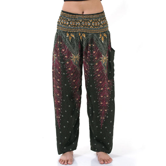 Close-up of green Thai harem yoga pants with peacock print