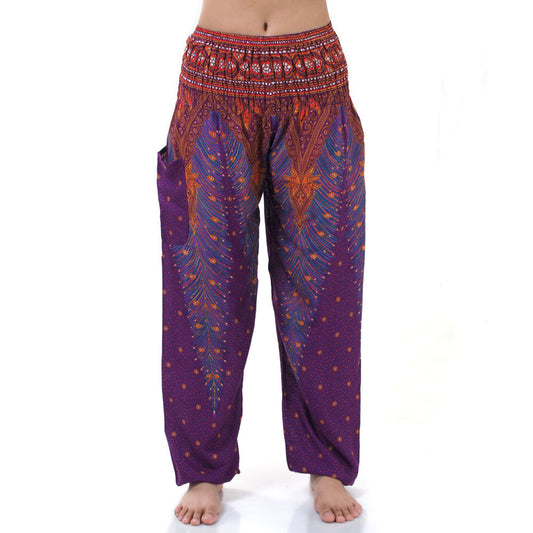 Close-up of purple Thai harem yoga pants with peacock print