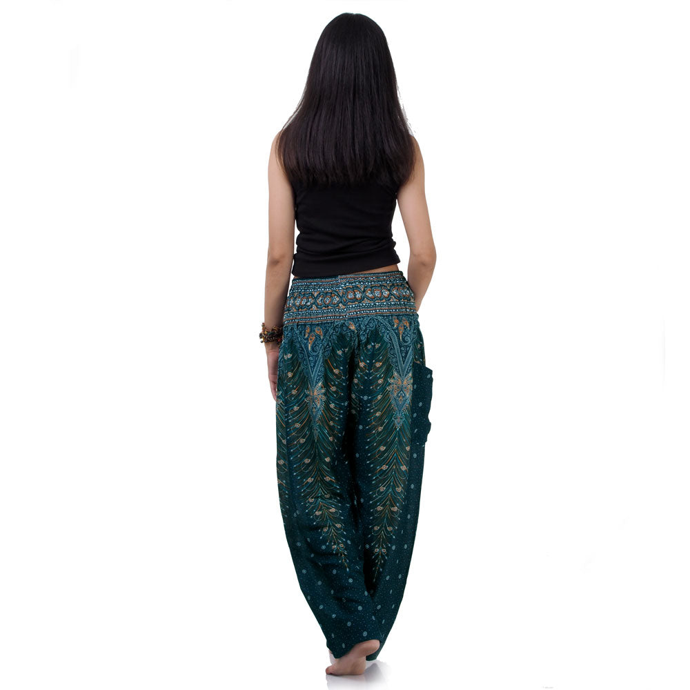 Back view of turquoise Thai harem yoga pants with peacock print worn with black top