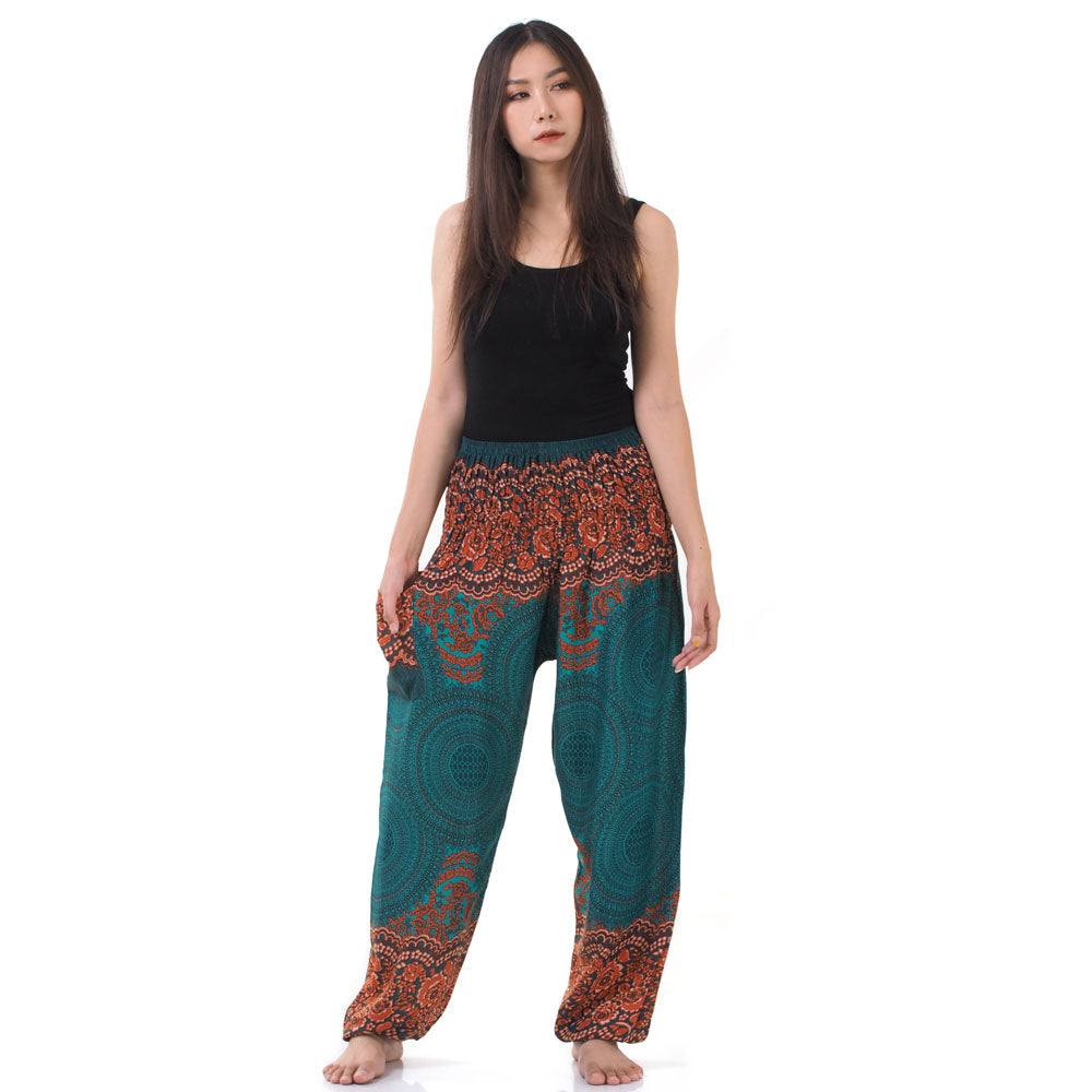 Model wearing turquoise Thai harem yoga pants with mandala print and black top, front view