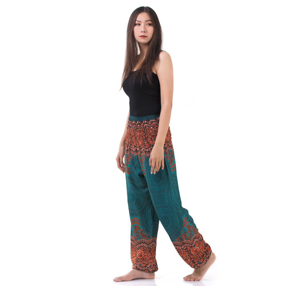 Side view of model in turquoise Thai harem yoga pants with mandala print and black top