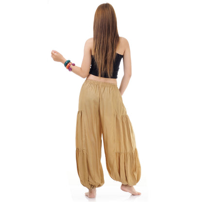 Back view of beige women Thai yoga harem pants worn with black shirt