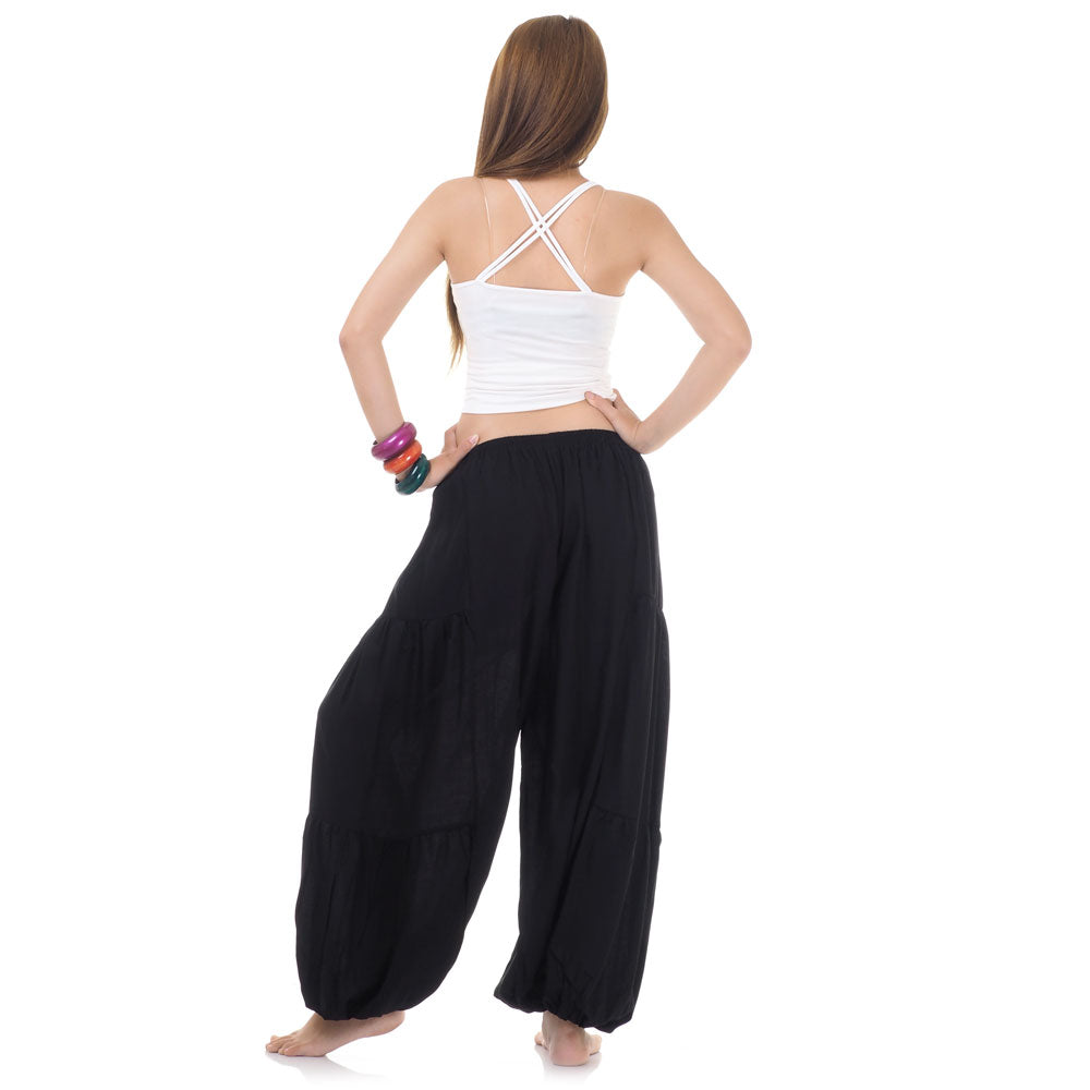 Back view of black women Thai yoga harem pants worn with white top