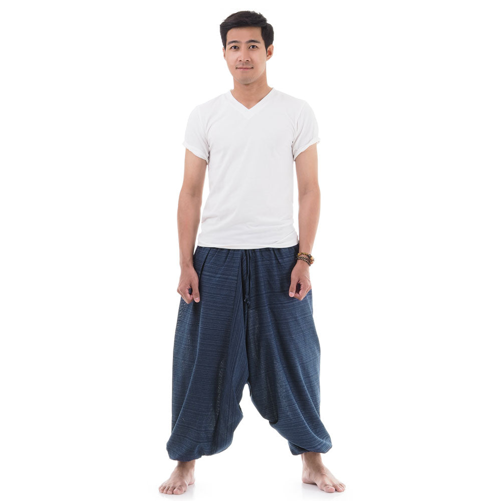Male Model wearing blue pinstripe drop crotch Thai harem pants with white shirt, front view