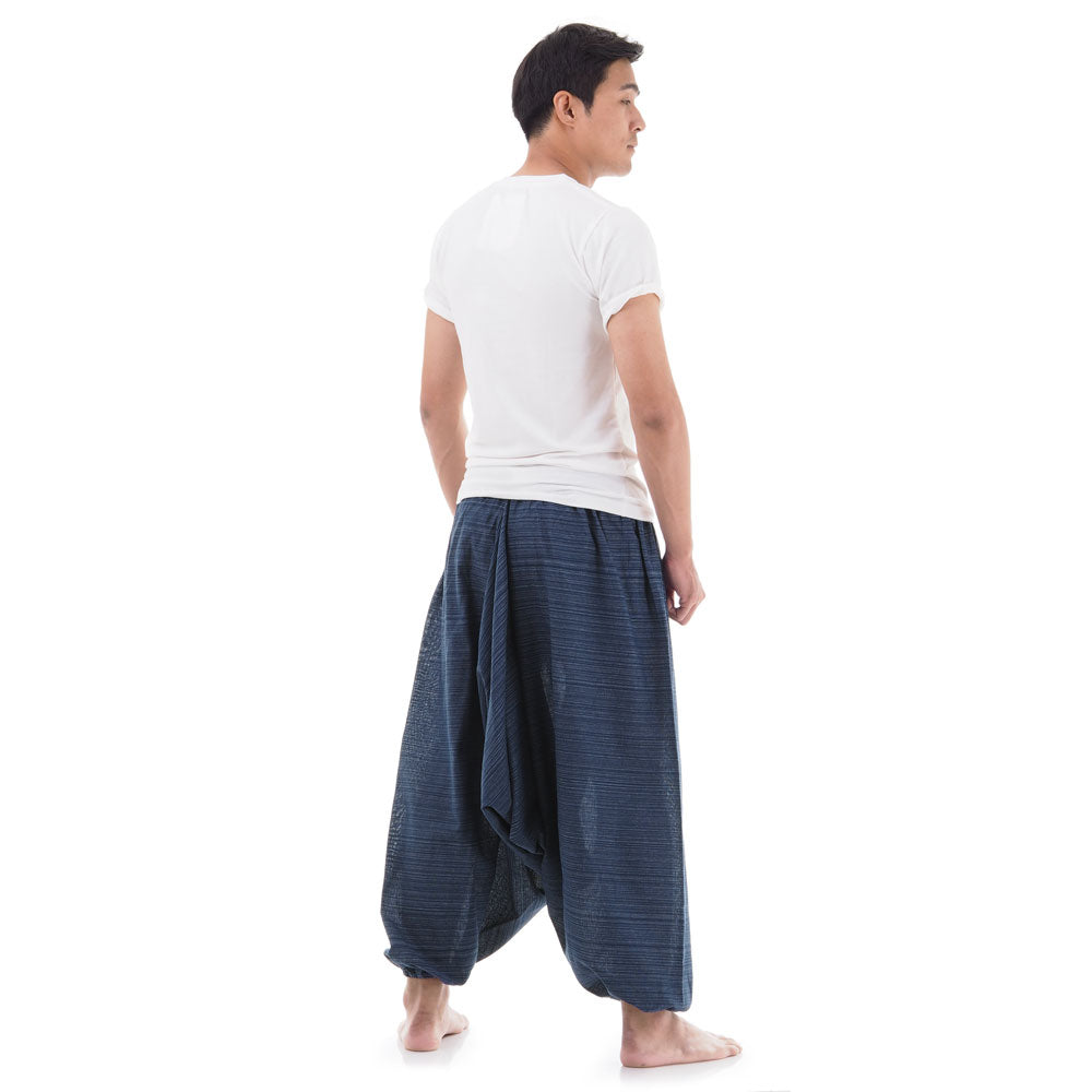 Back view of blue men pinstripe drop crotch Thai harem pants worn with white shirt