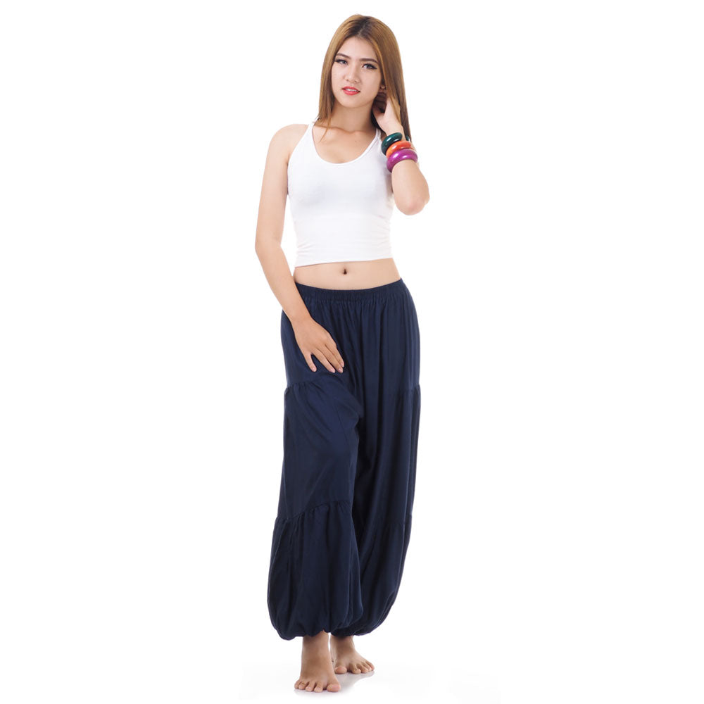 Female model wearing a blue women Thai harem yoga pants with white top, front view