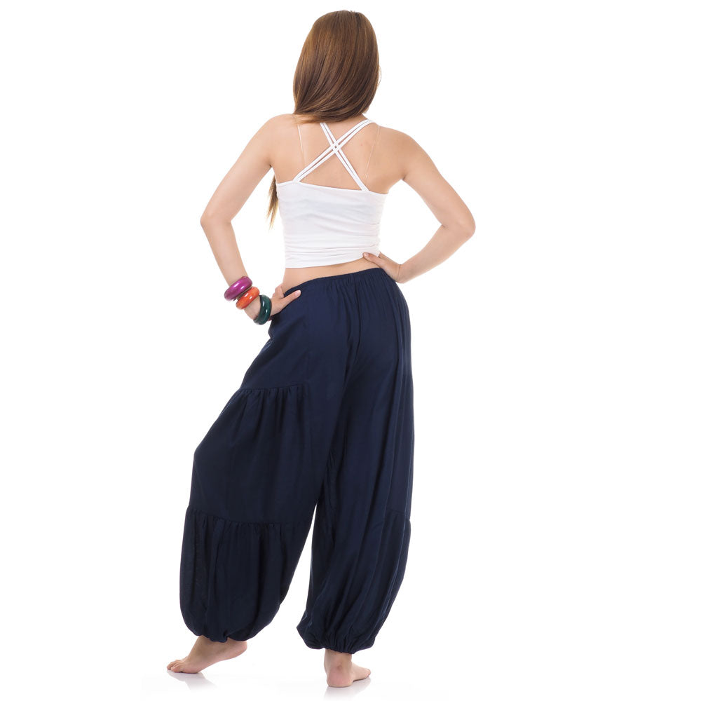 Back view of blue women Thai yoga harem pants worn with white top