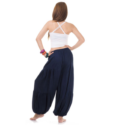 Back view of blue women Thai yoga harem pants worn with white top
