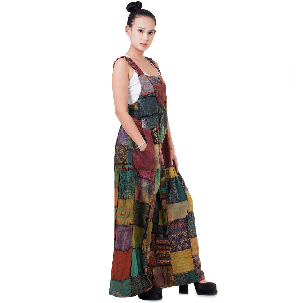 Side view of brown boho patchwork overall jumpsuit showing the wide-leg silhouette.