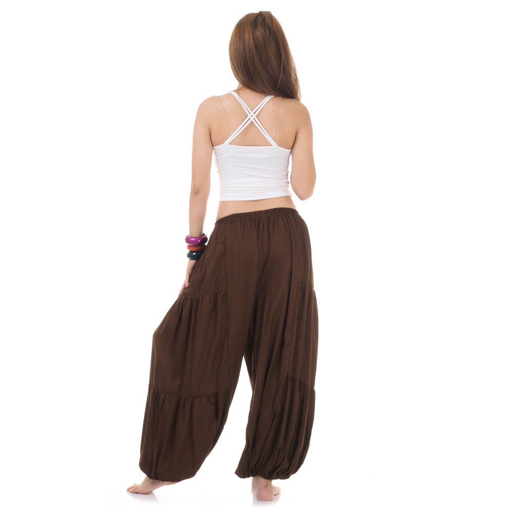Back view of brown women Thai yoga harem pants worn with white top