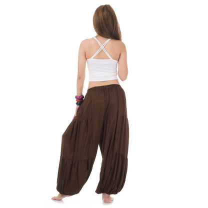 Back view of brown women Thai yoga harem pants worn with white top