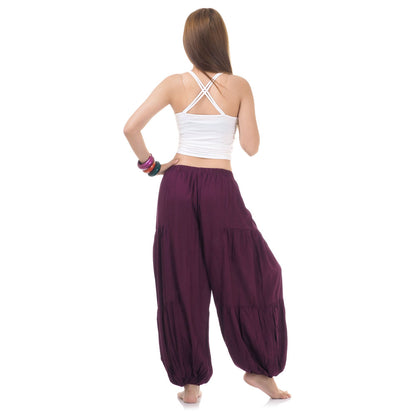 Back view of burgundy women Thai yoga harem pants worn with white top