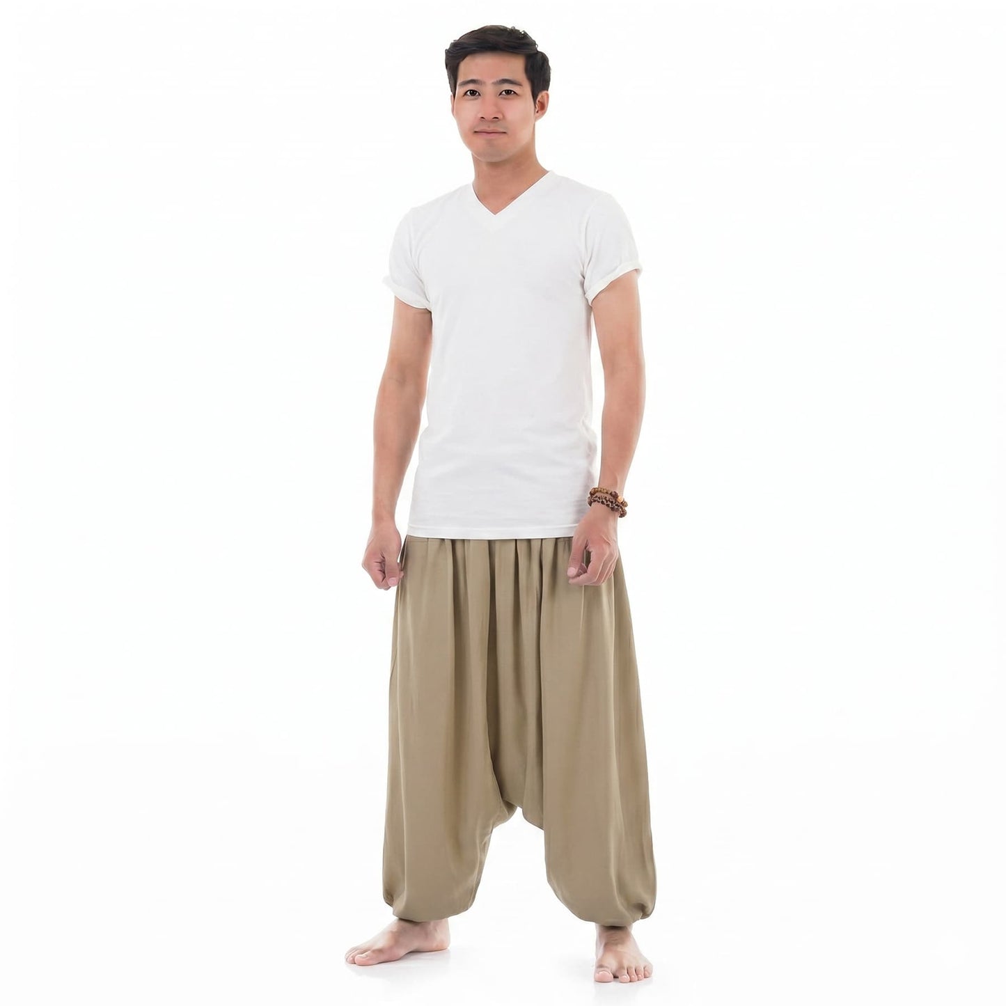Side view of the sand-colored Men's low crotch pants, displaying the traditional wide baggy design.