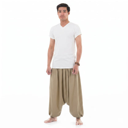 Side view of the sand-colored Men's low crotch pants, displaying the traditional wide baggy design.