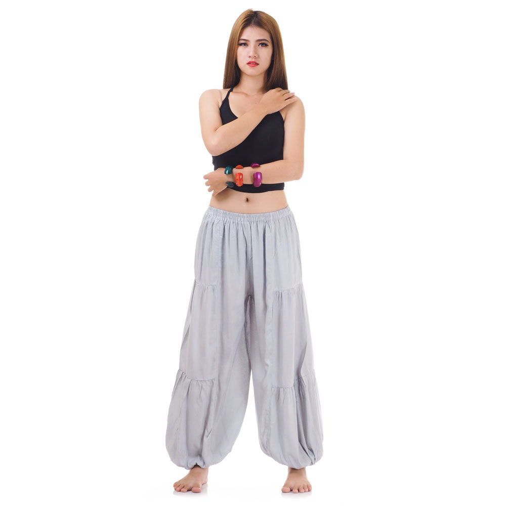 Female model wearing a gray women Thai harem yoga pants with black shirt, front view