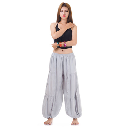 Female model wearing a gray women Thai harem yoga pants with black shirt, front view