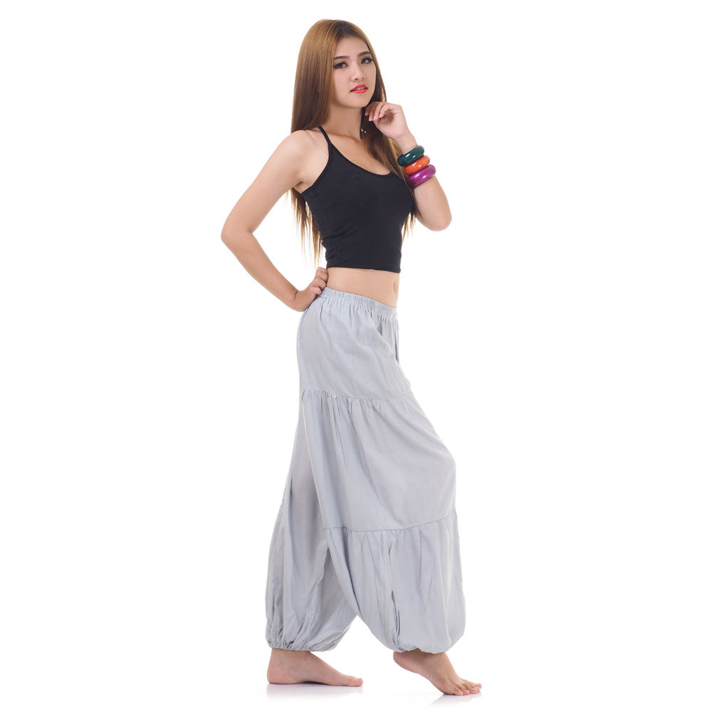 Side view of female model in gray women Thai harem yoga pants with black shirt