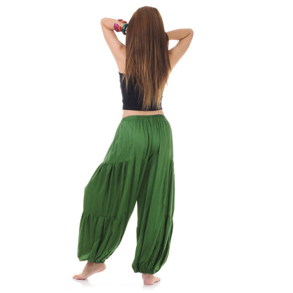 Back view of green women Thai yoga harem pants worn with black shirt