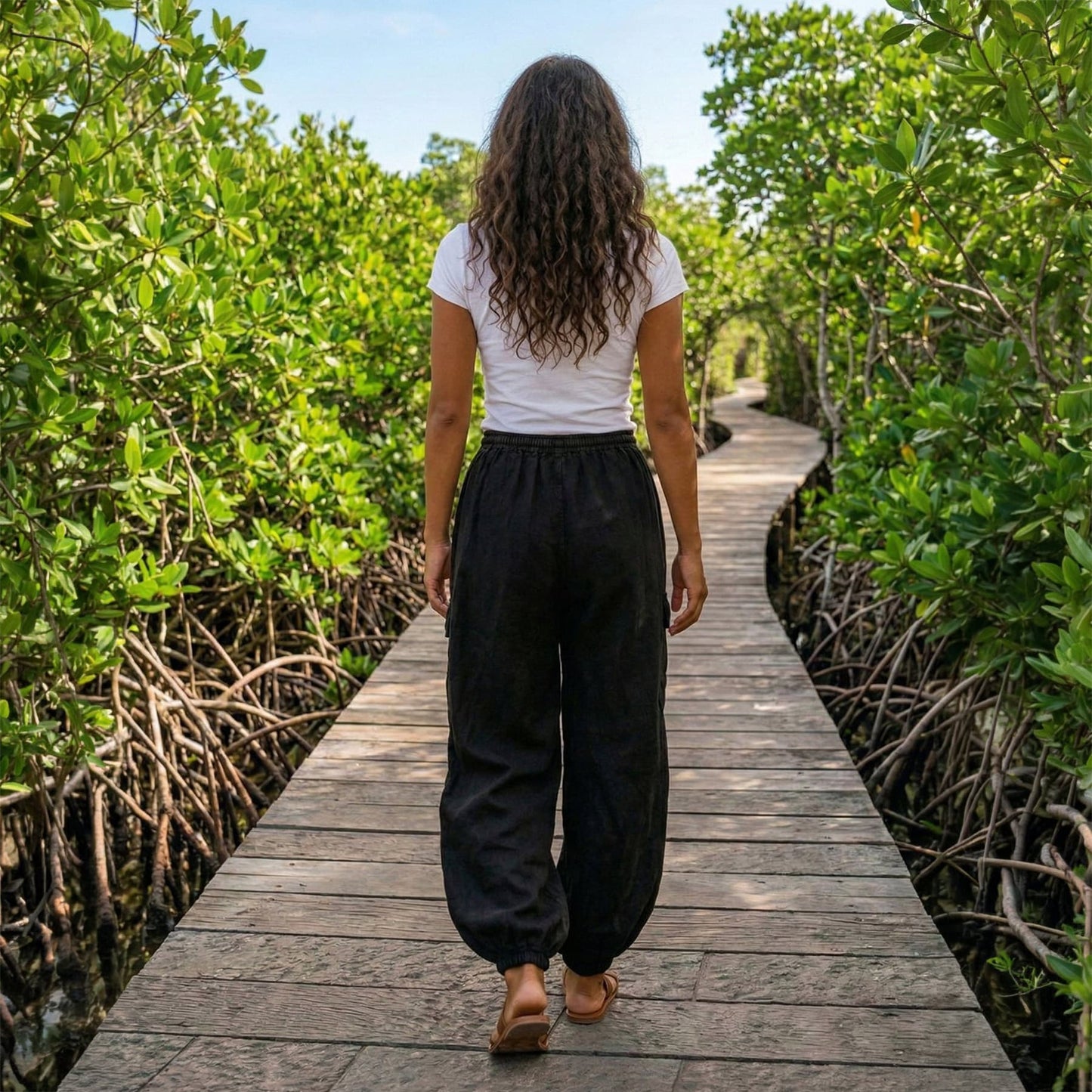 Back view of black boho stonewashed lotus harem pants showing the comfortable fit and elastic waist.