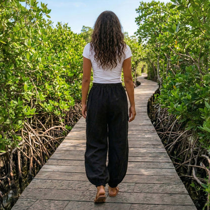 Back view of black boho stonewashed lotus harem pants showing the comfortable fit and elastic waist.