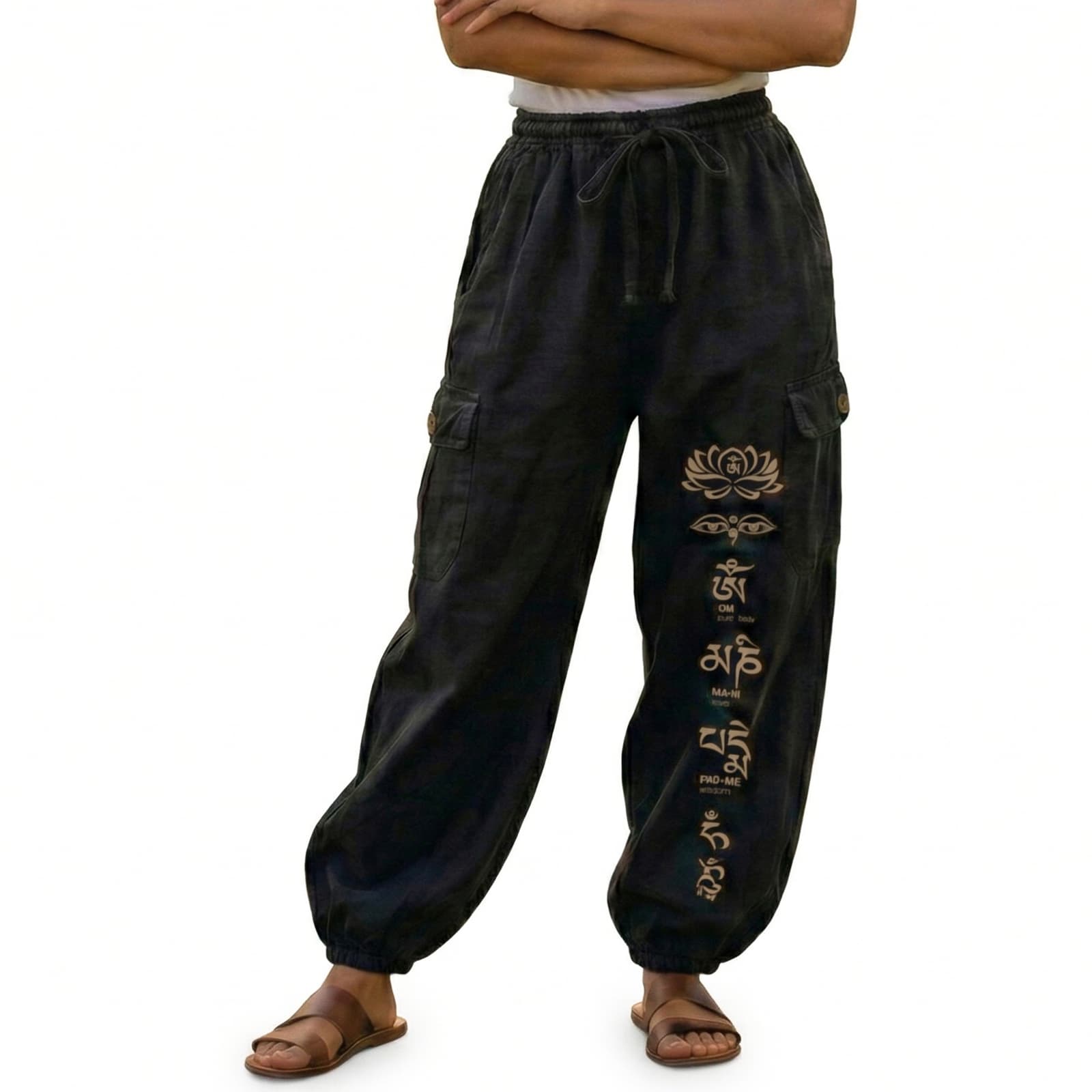 Close-up of black stonewashed lotus harem pants highlighting the contrasting floral prints and cargo seams.