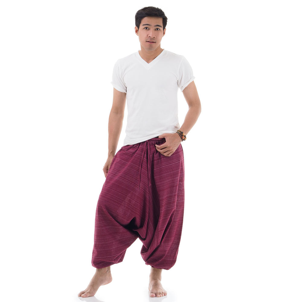 Male Model wearing maroon pinstripe drop crotch Thai harem pants with white shirt, front view