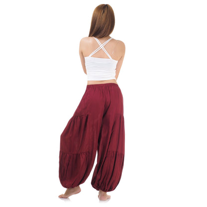 Back view of maroon women Thai yoga harem pants worn with white top