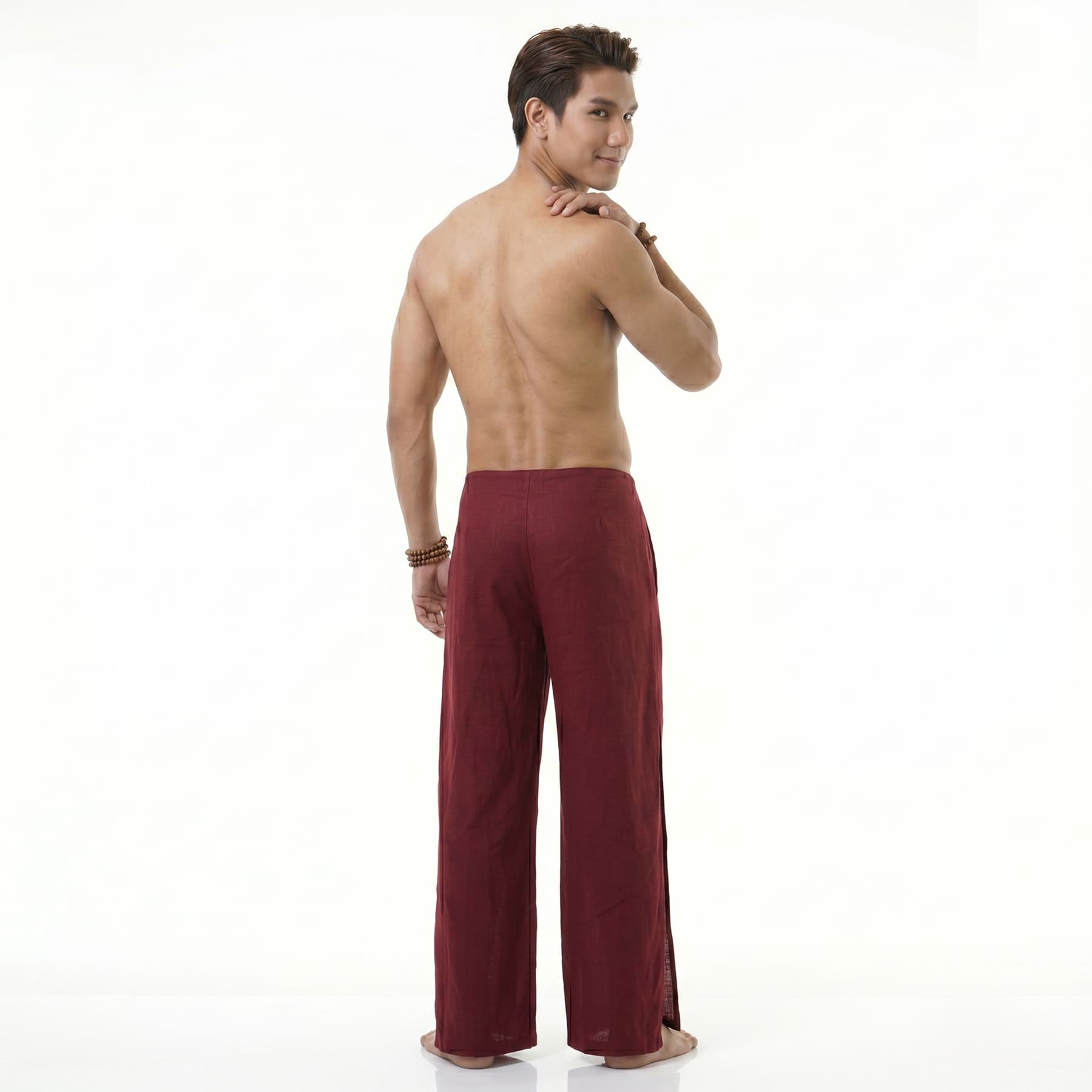 Rear view of the maroon Men's Thai wrap pants, showcasing sustainable and relaxed festival fashion.
