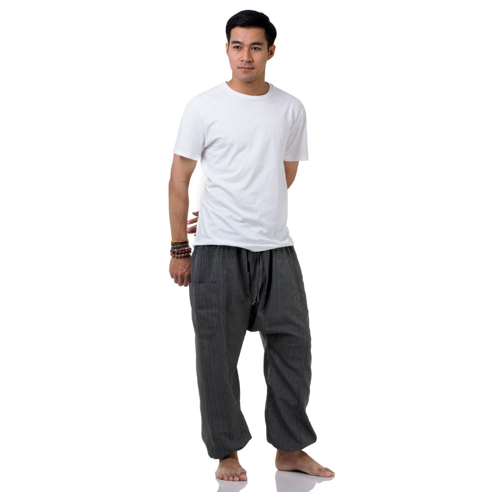Side profile of the gray pinstripe pants, highlighting the loose and sophisticated harem silhouette.