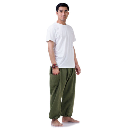 Side profile of the Jungle Green pants, featuring the elastic ankle cuffs and loose fit.
