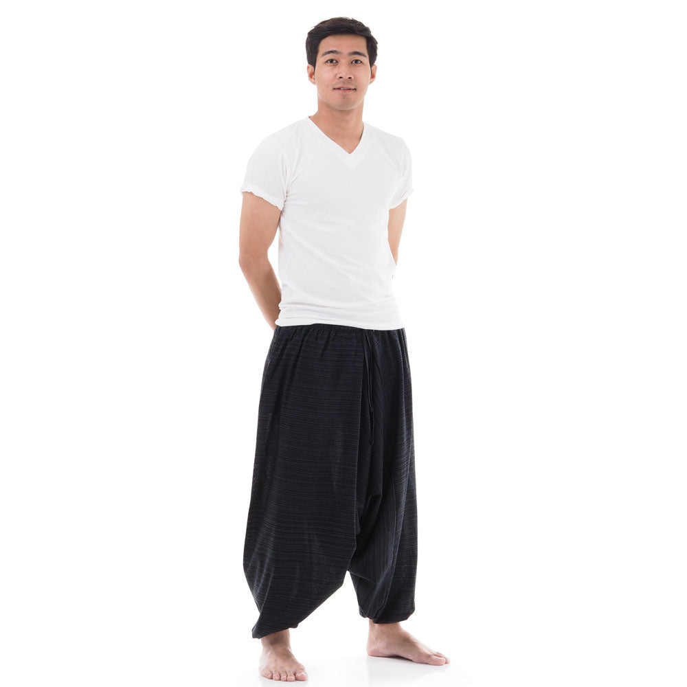 Male Model wearing Black pinstripe drop crotch Thai harem pants with white shirt, front view