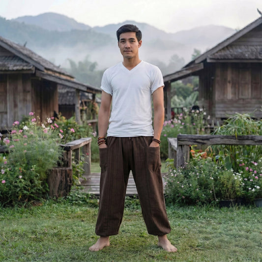 Male model in Mahogany Brown pinstripe pants standing in a park, reflecting an earthy aesthetic.