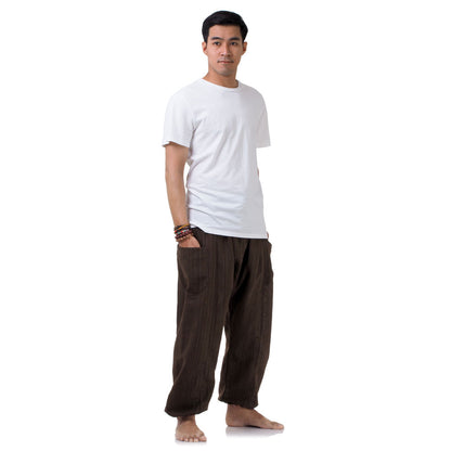 Side view of the brown pinstripe pants, highlighting the signature loose and airy cut.