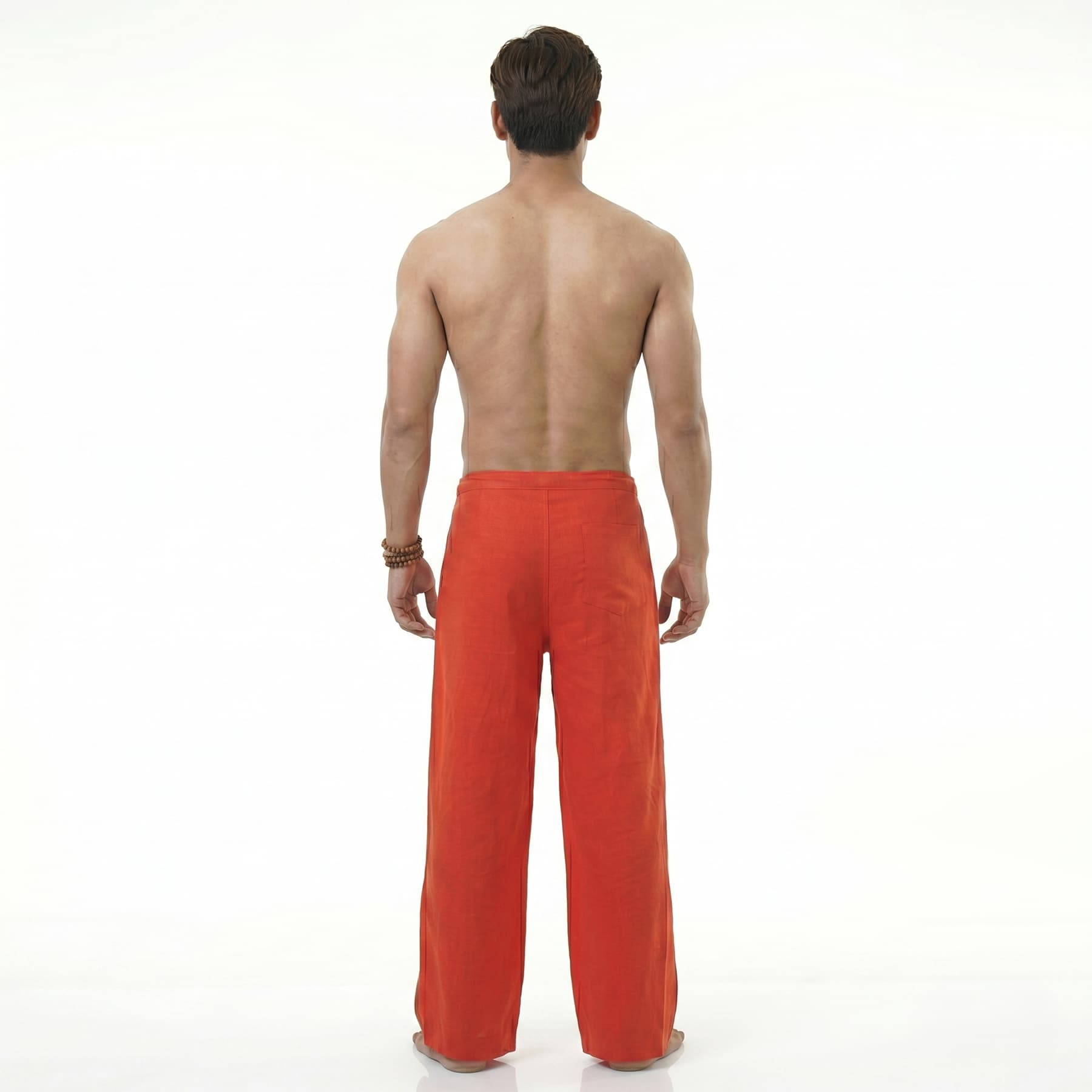 Back view of the red Men's Thai wrap pants, highlighting the comfortable fit for beachwear.