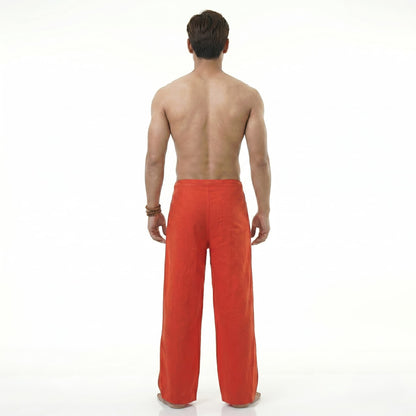 Back view of the red Men's Thai wrap pants, highlighting the comfortable fit for beachwear.