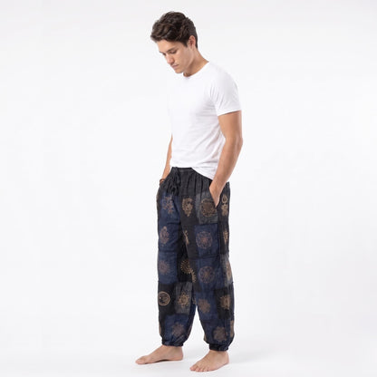 Side view of the black organic cotton harem pants for men, highlighting the comfortable drape and elastic ankle cuffs.