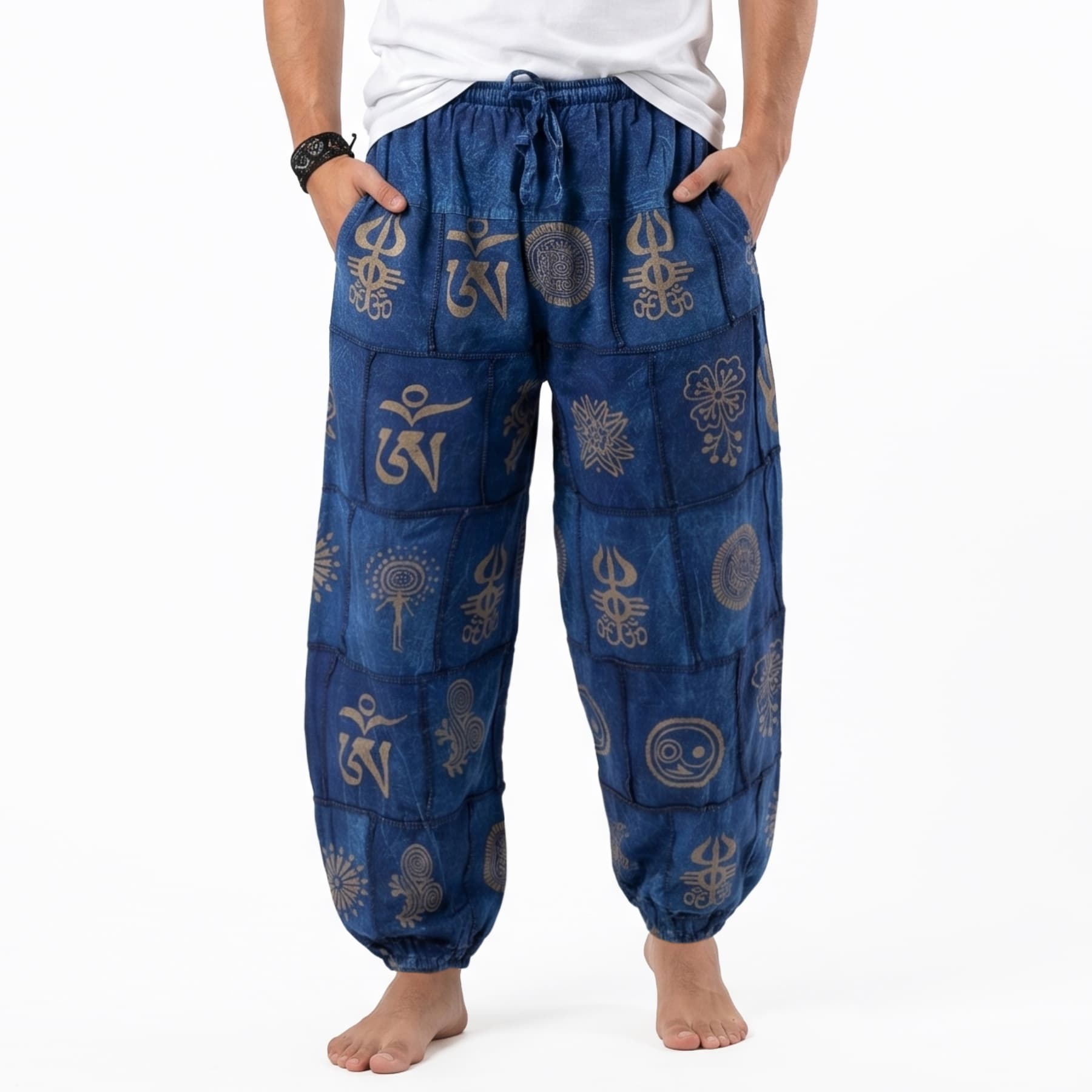 Close-up detail of the blue stonewashed organic cotton harem pants for men, highlighting the tribal pattern and soft fabric texture.